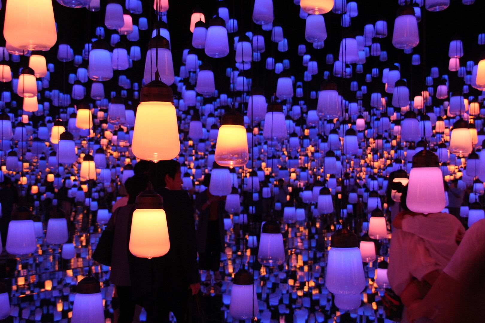 Visitors exploring an immersive exhibition-like interior in Tokyo